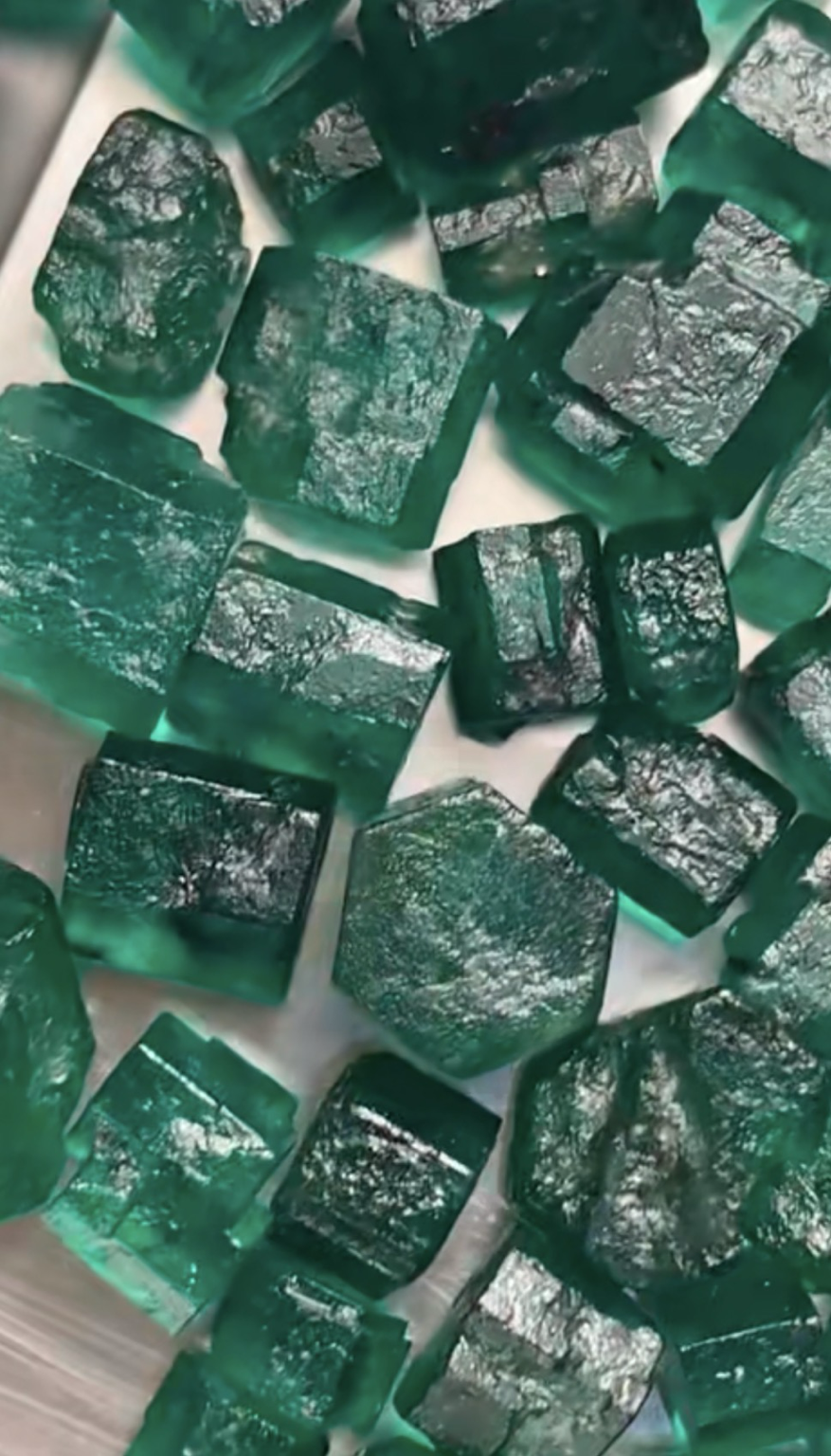 Rough emerald crystals showing visible morphology and surface features